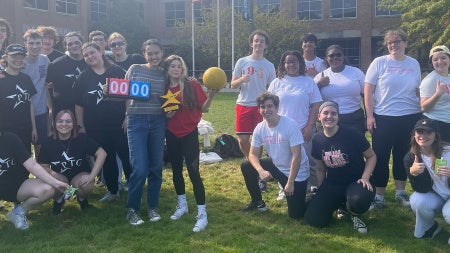 A group of students from Players' Theatre Group pose together on campus