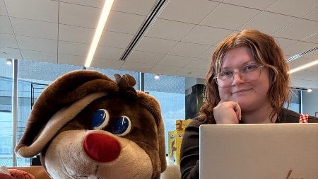 Heather O Brien with an open laptop and the Nestle Quick Rabbit