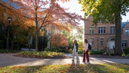 View of students walking on CWRU campus in autumn. 