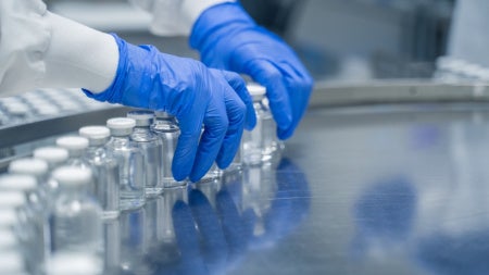 Detail of hands working in pharmaceutical factory