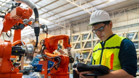 Image of a male operating machinery in a manufacturing company