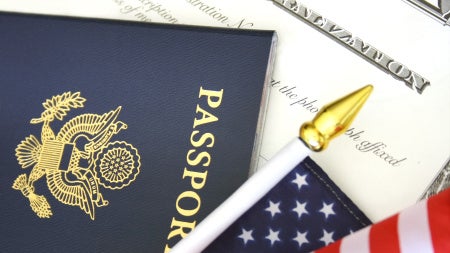 Image of U.S. passport , flag and naturalization documents