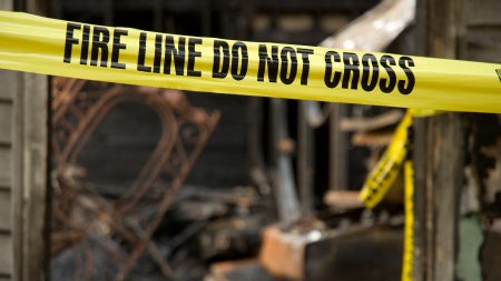 Image of yellow tapes at a fire scene