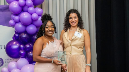 Angela Newman-White (left) receives the 2026 Community Legacy Award
