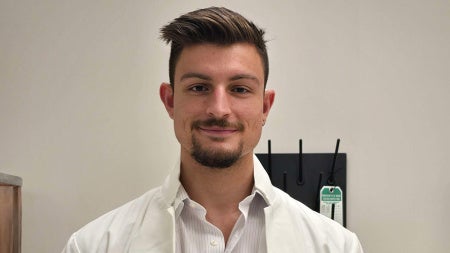 Photo of Cedric Levi in a white lab coat