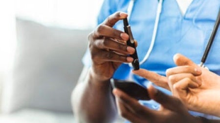 Blood sugar being tested with finger prick