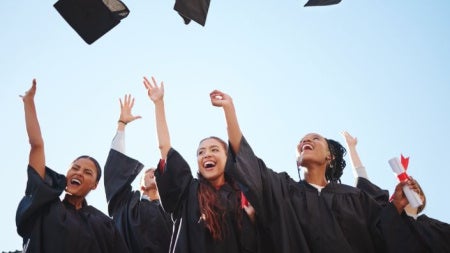 Graduates throwing hats in the air