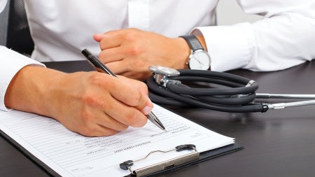 doctor-filling-out-paperwork
