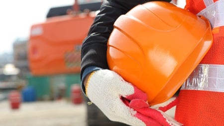 worker-holding-construction-helmet