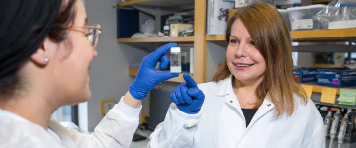 Agata Exner looking at materials in a lab with a student
