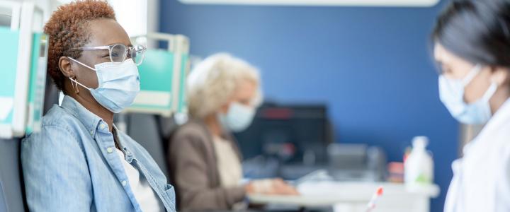 Photo of a patient with a healthcare professional during a cancer clinical trial