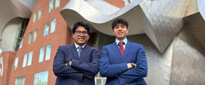 Dev Gupta and Sunveer Chugh pose for a photo in front of the Peter B. Lewis Building
