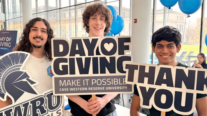 Students holding signs expressing thanks