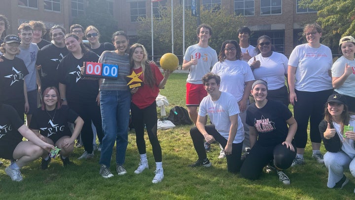 A group of students from Players' Theatre Group pose together on campus
