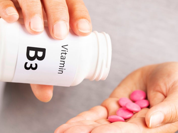 Close up of hands holding Vitamin B3 pills