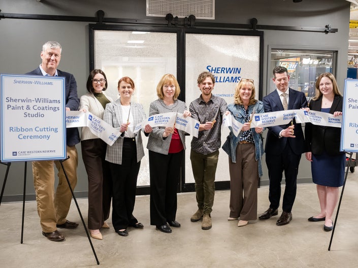 People stand for a ribbon cutting of the new Sherwin-Williams Paint and Coatings Studio in think[box]