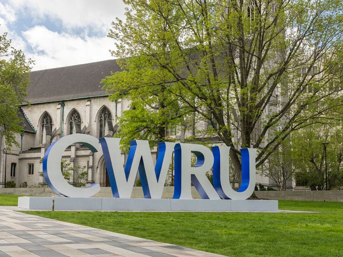 A campus setting with large block letters that read CWRU.