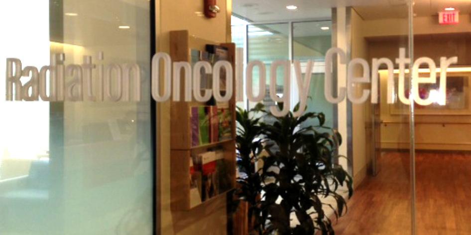 A glass door with the text "Radiation Oncology Center" on the glass