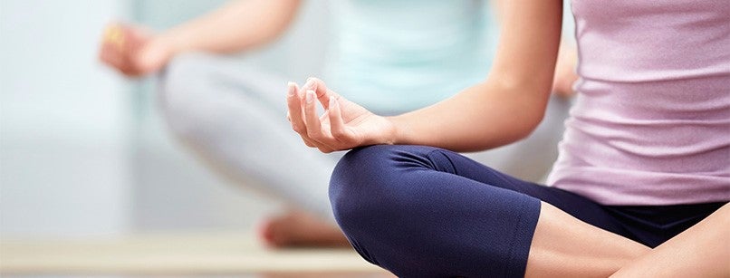 A woman doing yoga and meditating