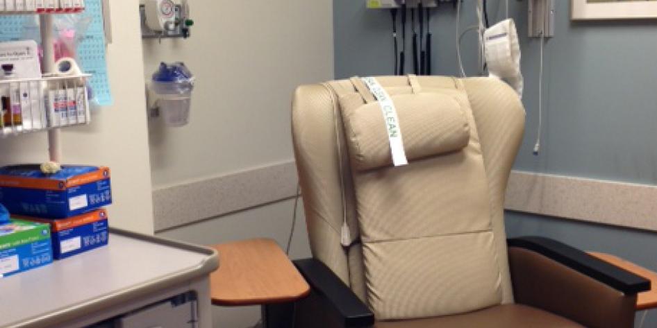 A large leather chair with cushion and a place for the patient's arm to rest during treatment