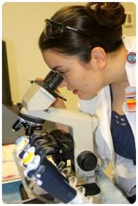 Photo of CWRU FPB nursing student peering into Microscope