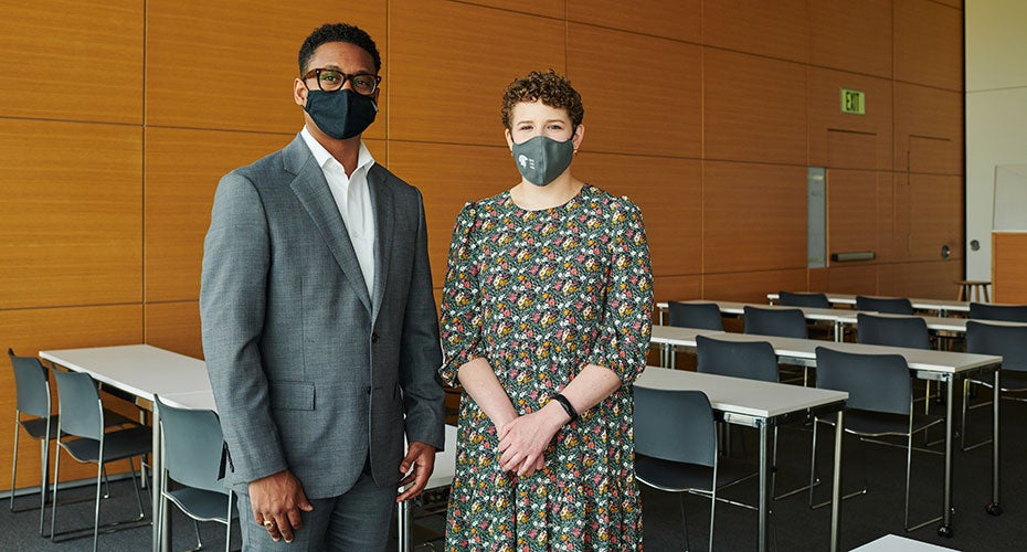 Wearing face masks, Associate Dean for Research Ron Hickman (left) and PhD alumna Julia O'Brien pose for a photo in the HEC.