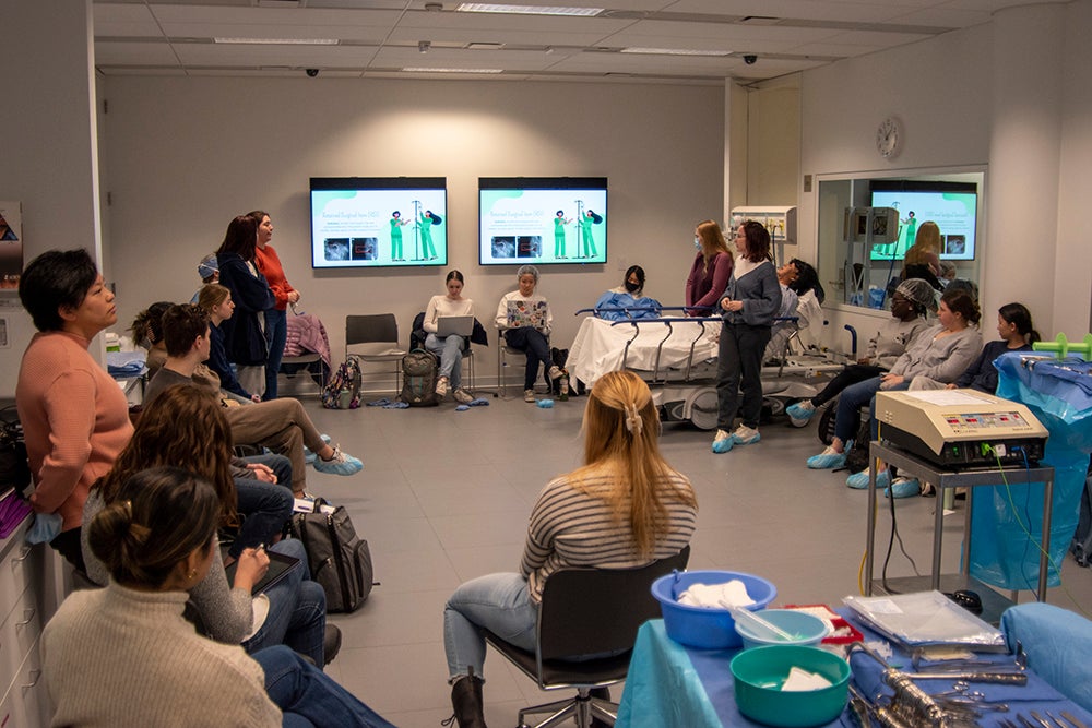 Students sit in a circle inside a nursing lab at CWRU