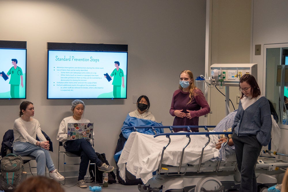 A nursing student in mask explains standard operating room procedures