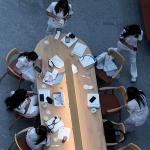 Nursing students gathering and studying at a table.