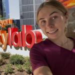Emilia Kunickas at right smiles outside the Shirley Ryan AbilityLab where she is an intern
