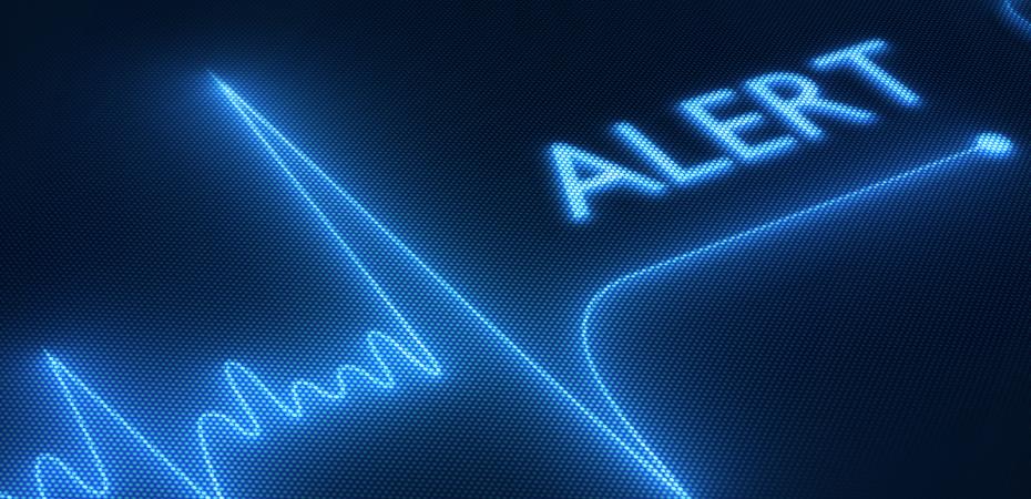 Stock image of an EKG test with an alert notification