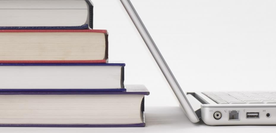 Stock photo of books and laptop computer