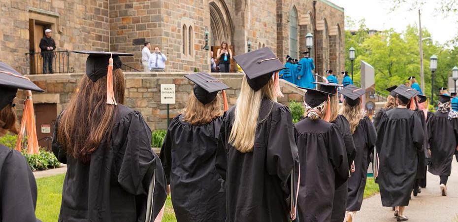 Nursing students at Case Western Reserve University wearing graduation robes and walking to their diploma ceremony.