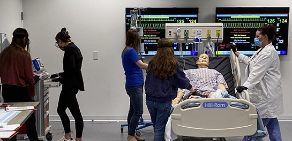 Nursing students working in a procedure lab test scenario.
