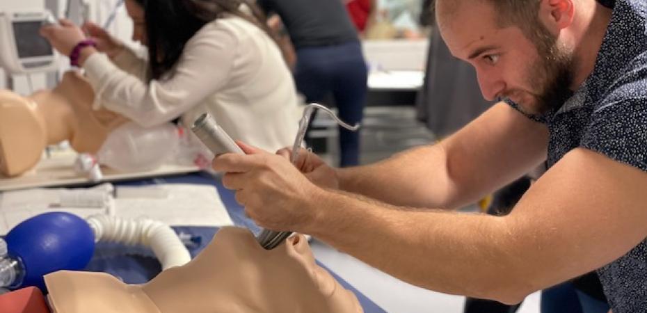 Nurse anesthesia student performing an airway lab on a manikin.