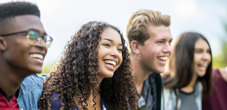 Group of young adults smiling and laughing.