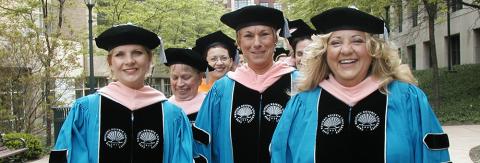 Picture of CWRU FPB students smiling at graduation.