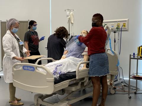 Nursing students practicing intubation and bagging a patient.