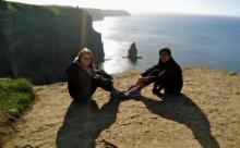 Picture of two CWRU FPB students posed in front of a sunset at sea.
