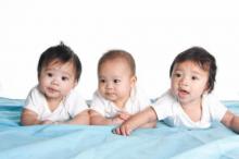Picture of three babies laying on their stomachs.