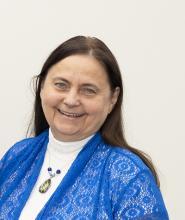 Jaclene Zauszniewski in blue blouse smiling