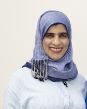 Zeyana Al Ismaili wearing blue headwrap smiling