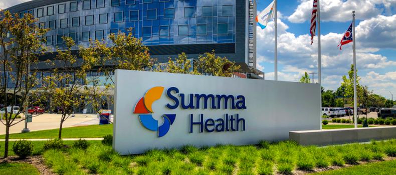 Glass walled hospital with Summa Health sign out front