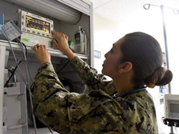 Suleika Stray monitors the vital signs of a patient at Camp Lemonnier
