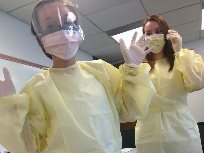 First-year School of Nursing students learn how to wear personal protective equipment (PPE).
