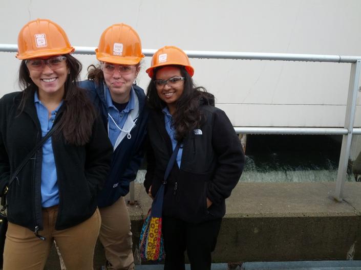 Grad Entry MN students Kristina Barney (left), Abigail Helman, and Sailja Patel stand outside the clean water reservoir during their public health field trip to the Northeast Ohio Sewer District Plant.