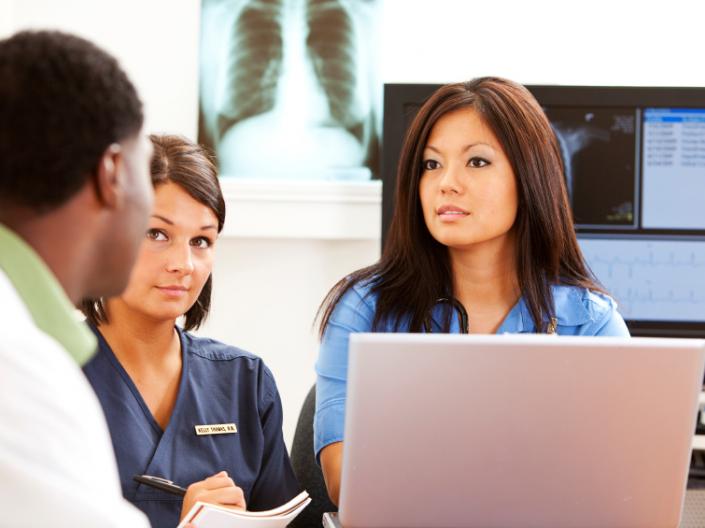 Stock photo of nurses discussing patient care.