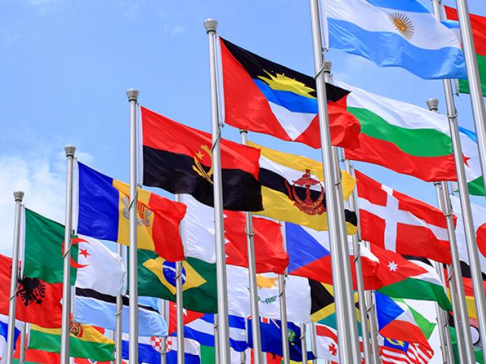 Collection of flags from all over the world blowing in the breeze.