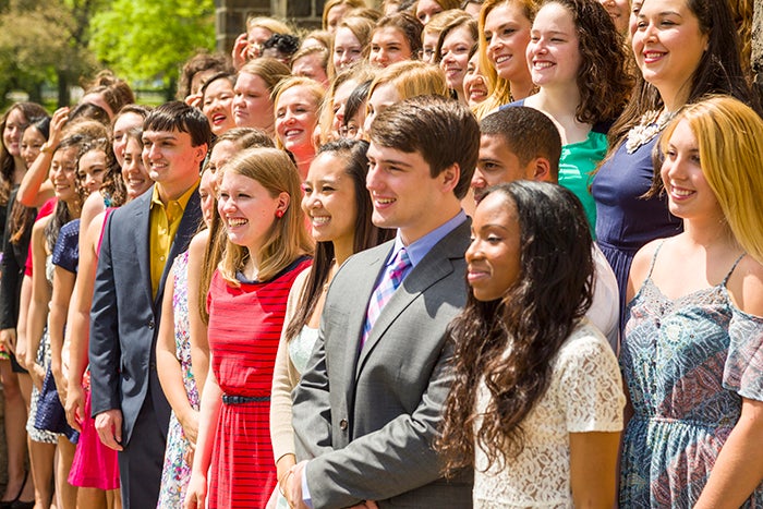 Photo of students smiling for a group photo.