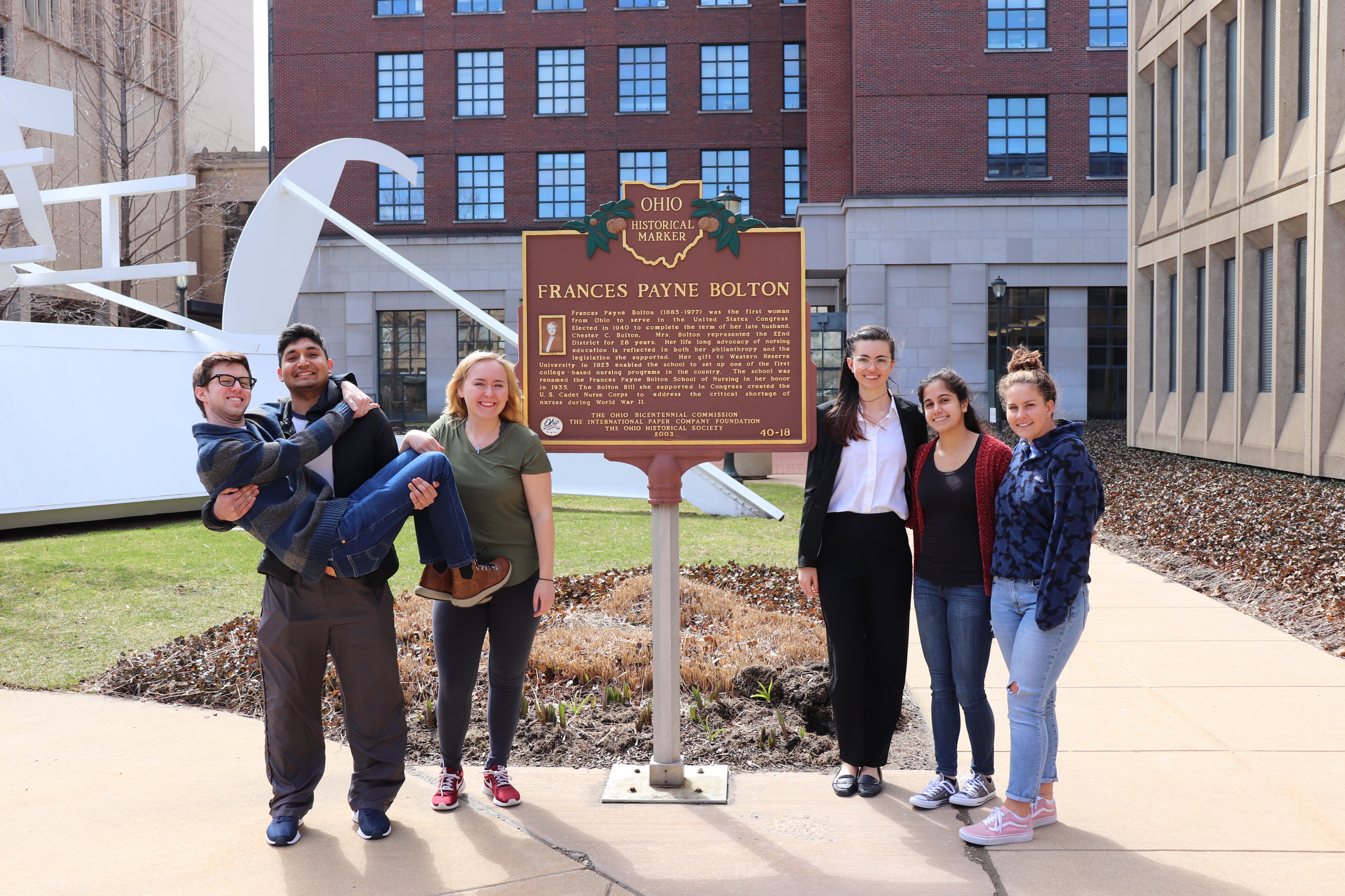 BSN students at the Frances Payne Bolton School of Nursing at Case Western Reserve University pose next to the historical marker for the FPB School of Nursing. 